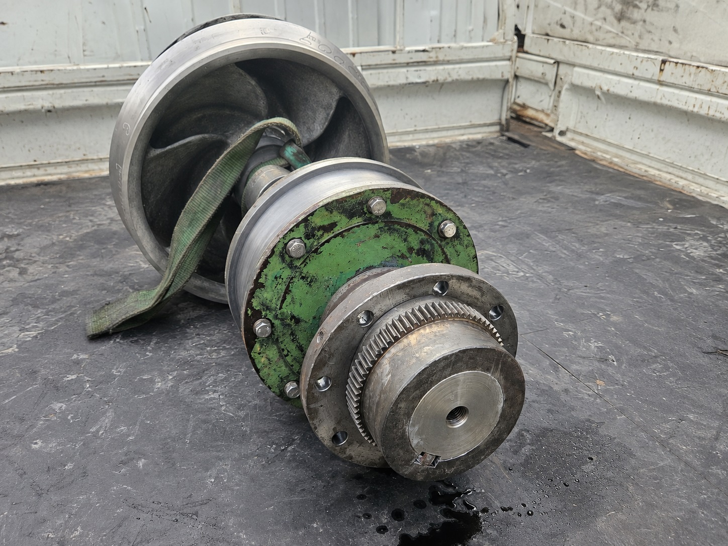 Removed industrial pump rotating assembly showing the impeller, shaft and associated components during repair assessment.