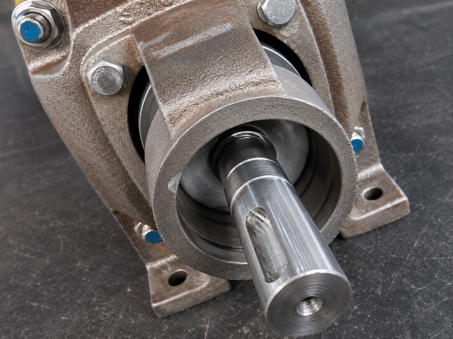 Close-up of an industrial pump shaft and bearing housing area during pump repair assessment.