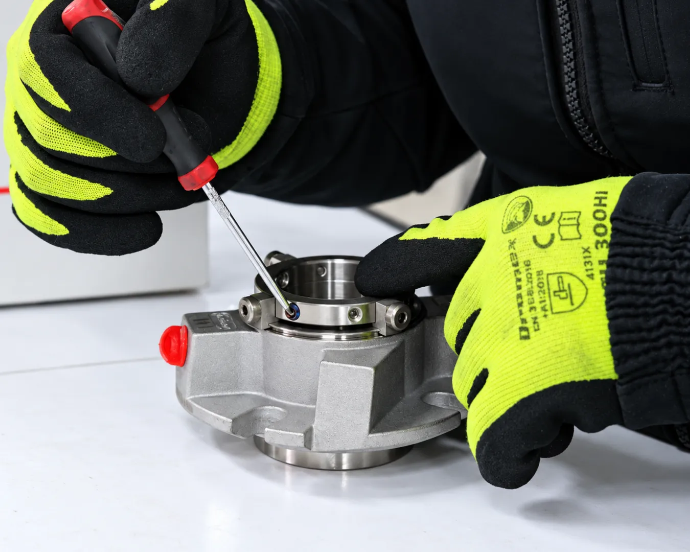 Technician adjusting a mechanical seal component during workshop repair work at PCS.